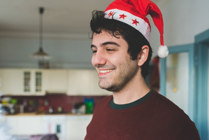 young man wearing santa claus hat smiling happiness christmas concept SBI 